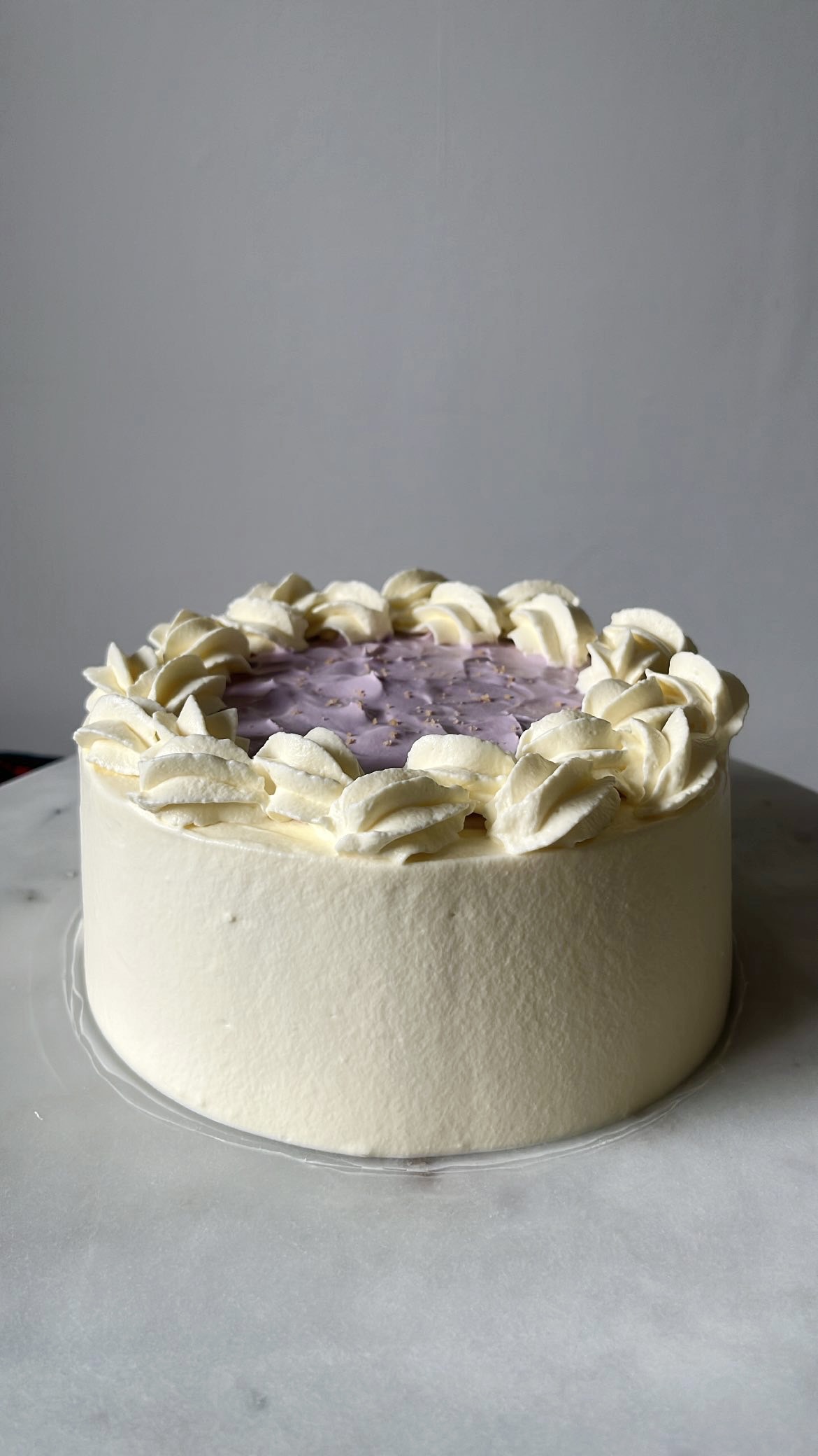 Cake topped with purple cream decoration for a vibrant touch